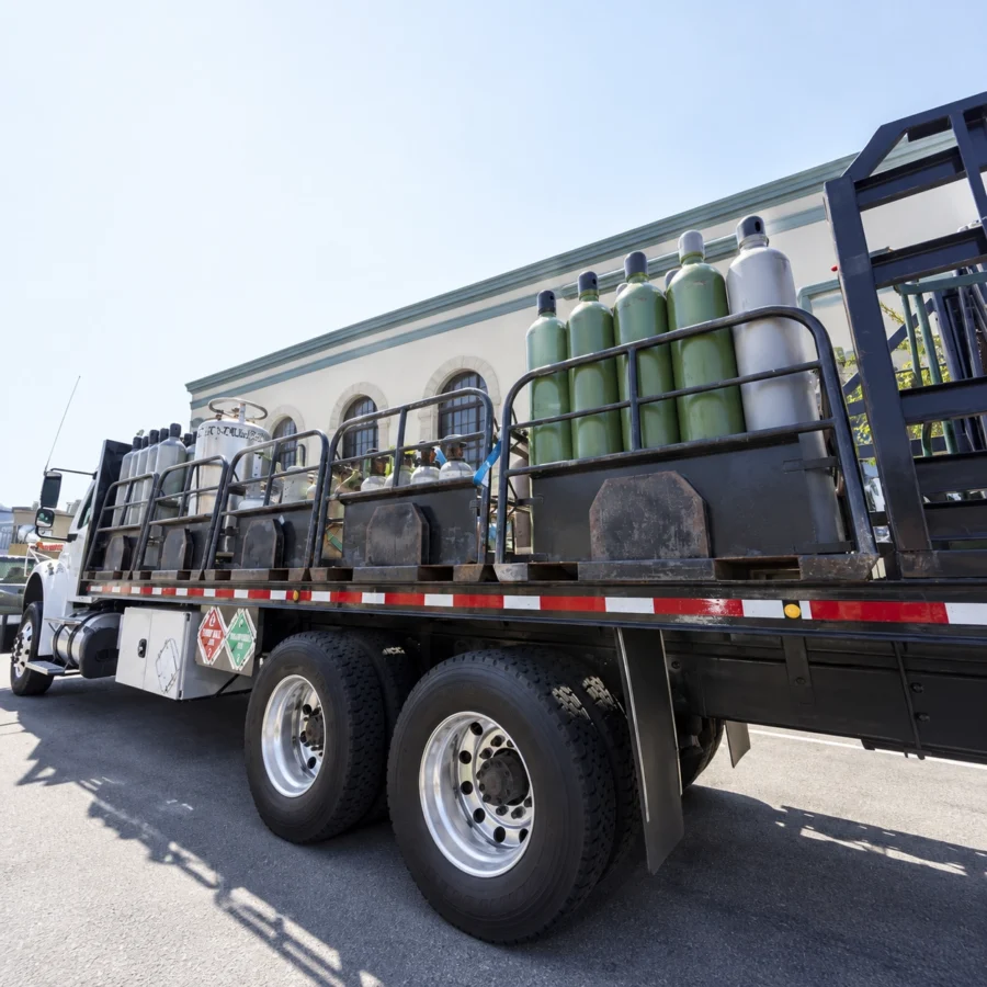 Industrial gas cylinders secured for road transport in a commercial vehicle